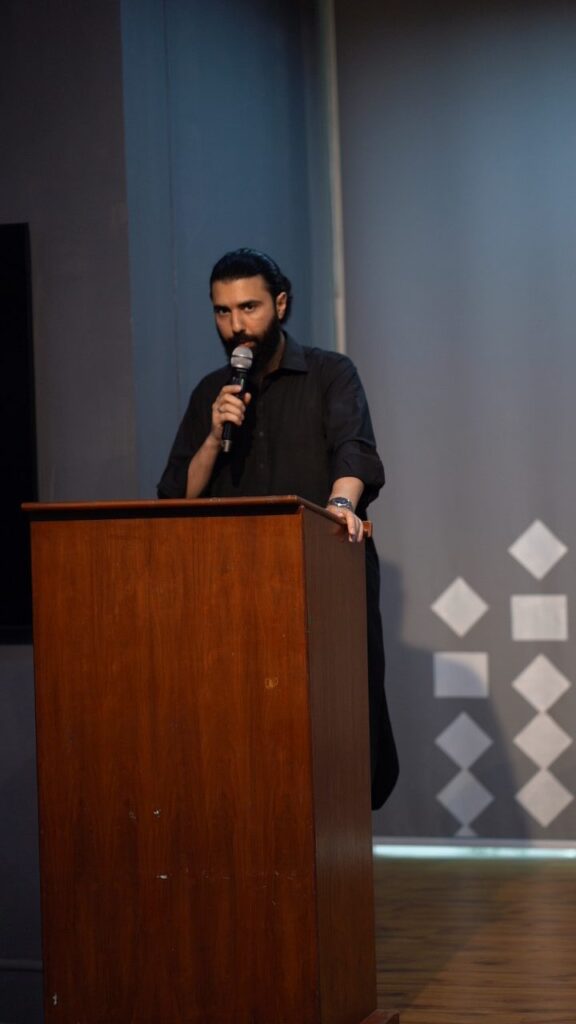 A host speaking from the podium