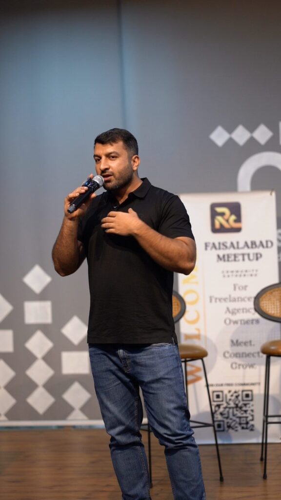 A speaker with a microphone at the front of the room