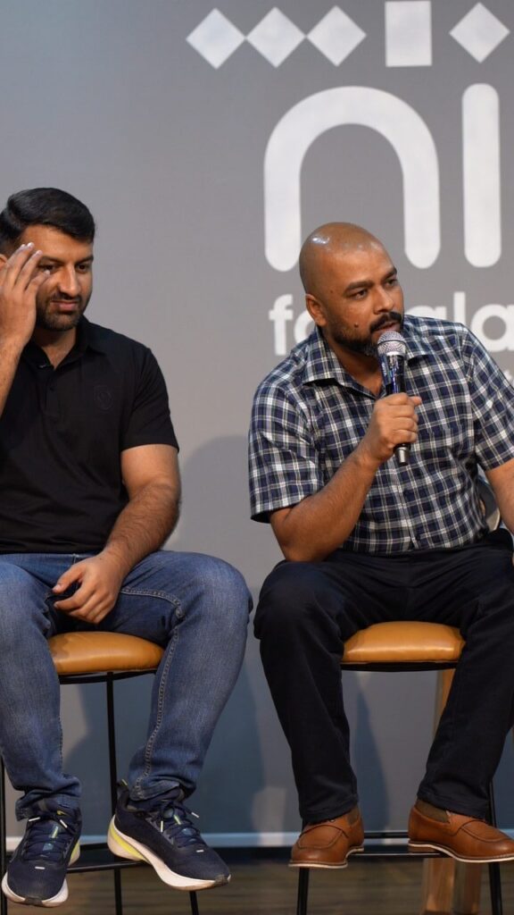 Two speakers in a fireside chat on stage