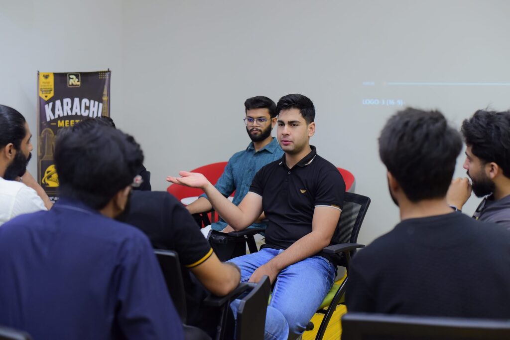 Attendees in a small group conversation at the Karachi meetup