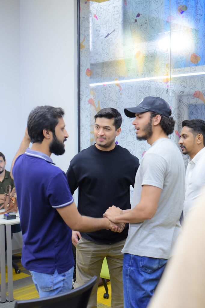 Attendees shaking hands before the talks