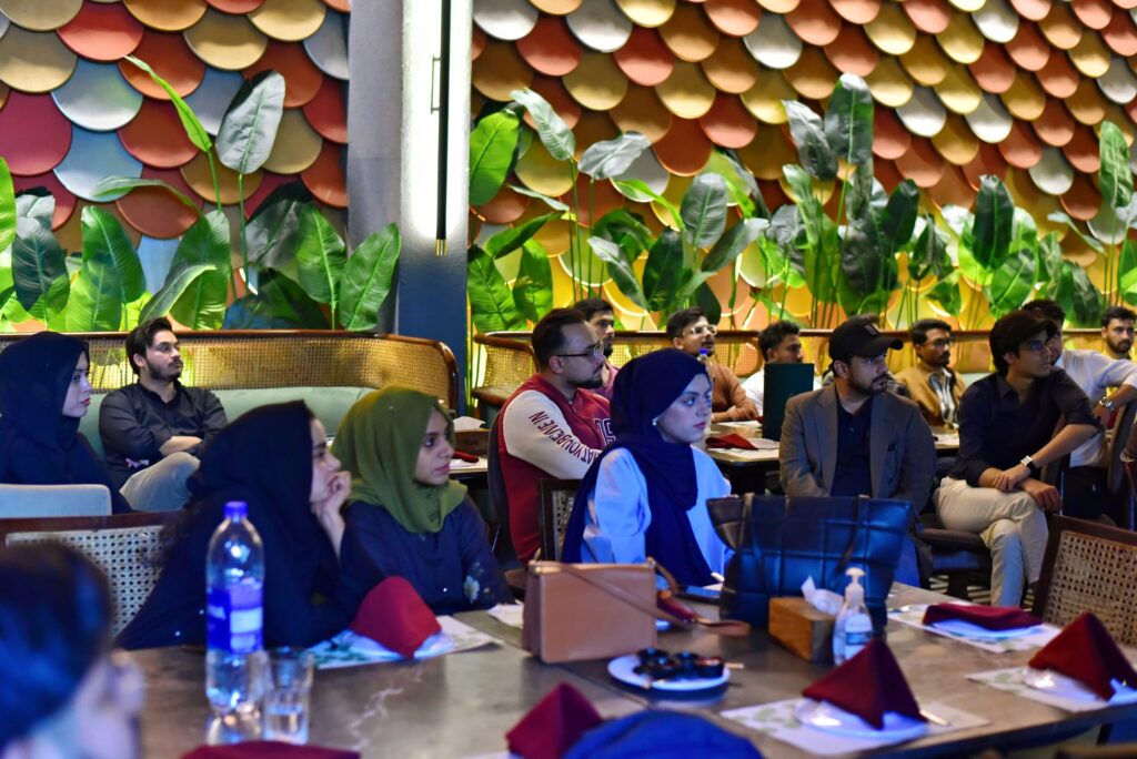 Attendees seated at tables across the venue