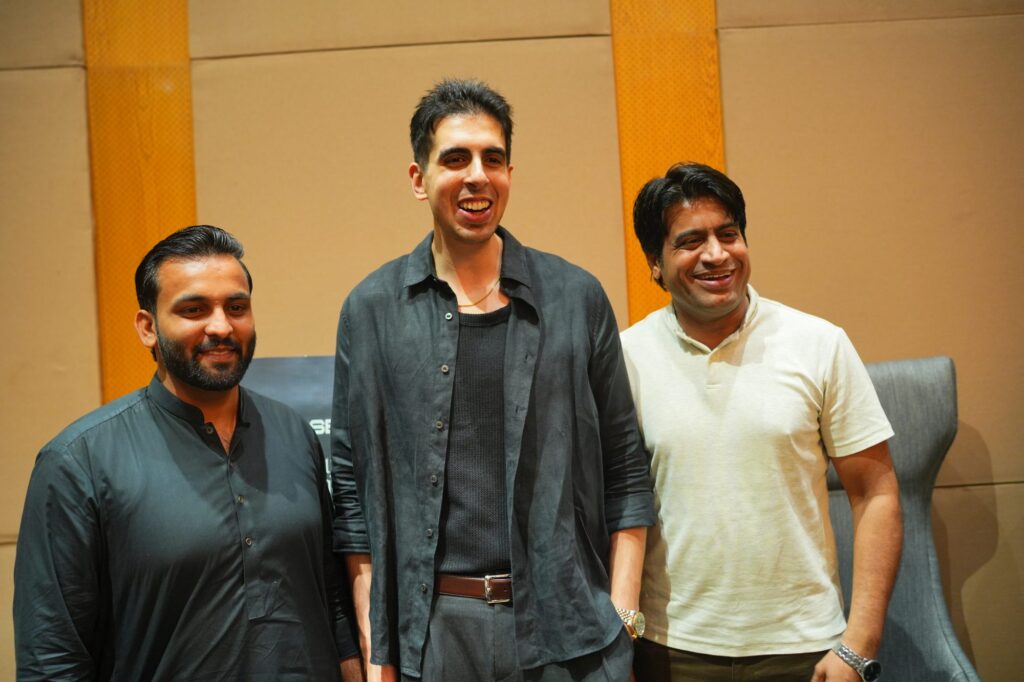 Three speakers smiling together after the panel