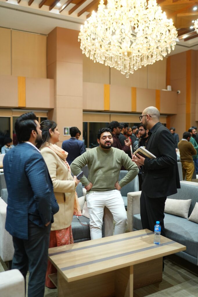 Attendees networking under the chandeliers