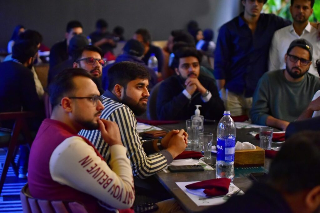 Attendees asking questions at their table