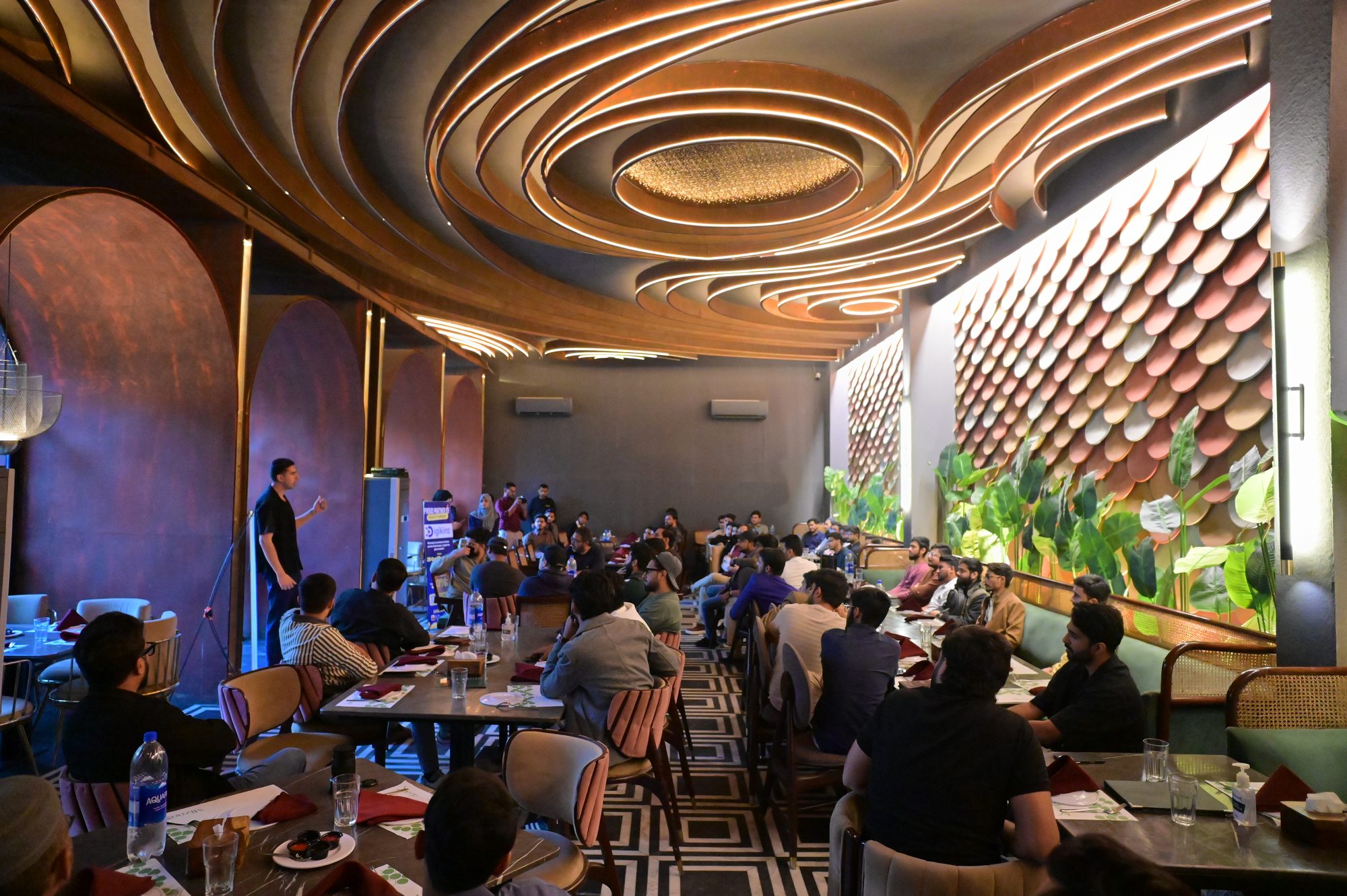 Attendees filling the tables of the Karachi venue
