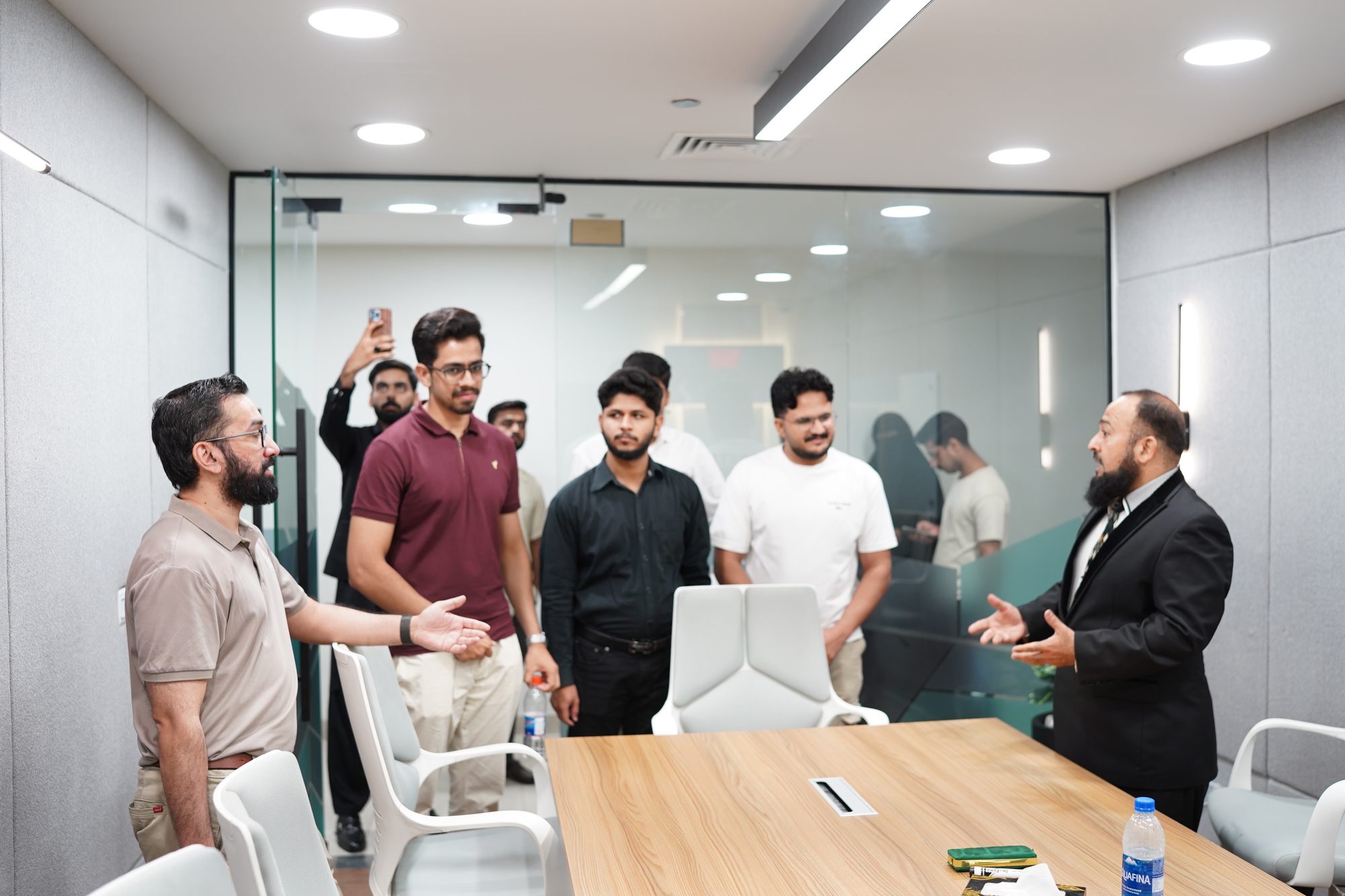 A host speaking to attendees in a Lahore meeting room