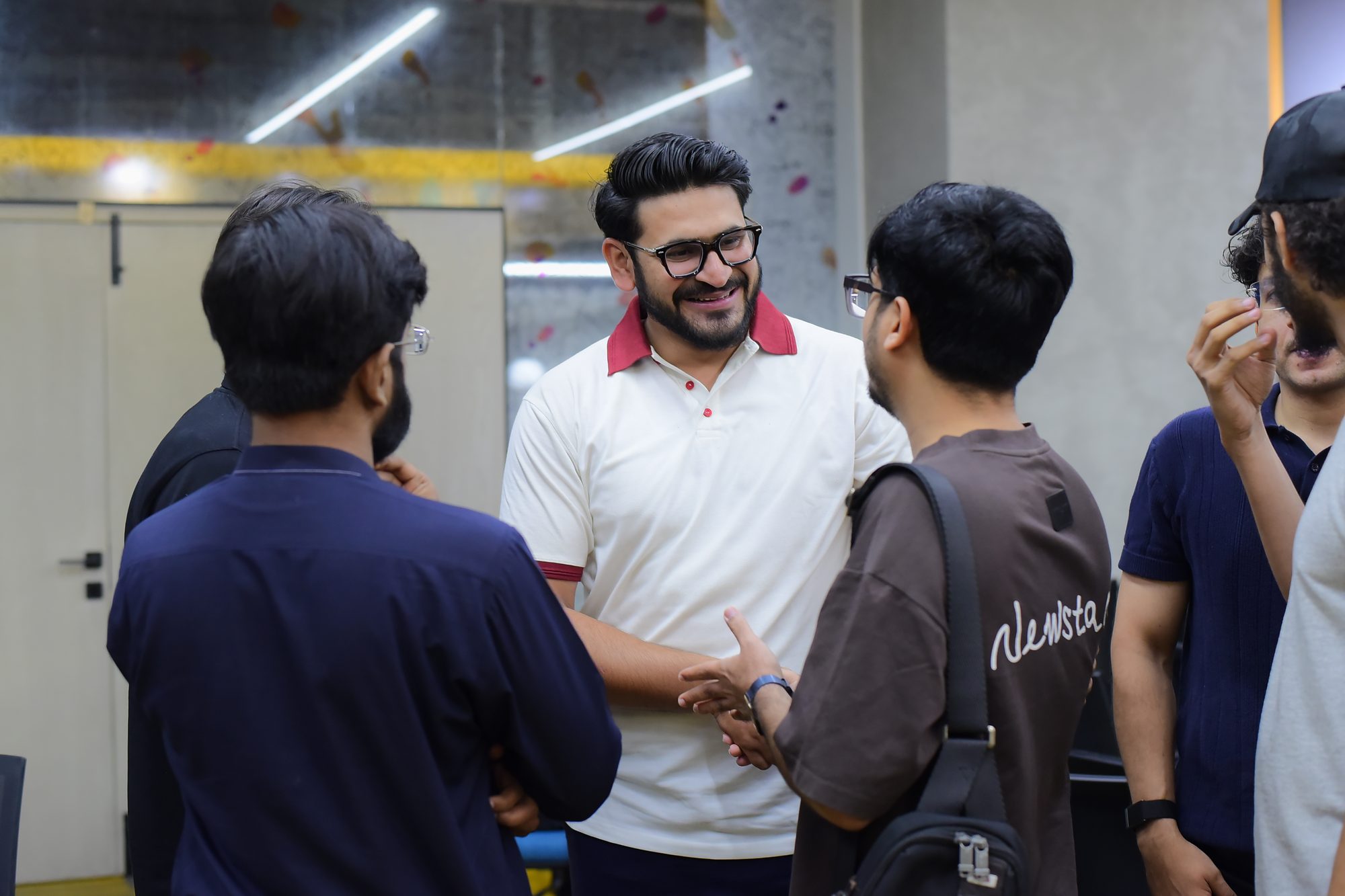 Attendees shaking hands and talking during open networking